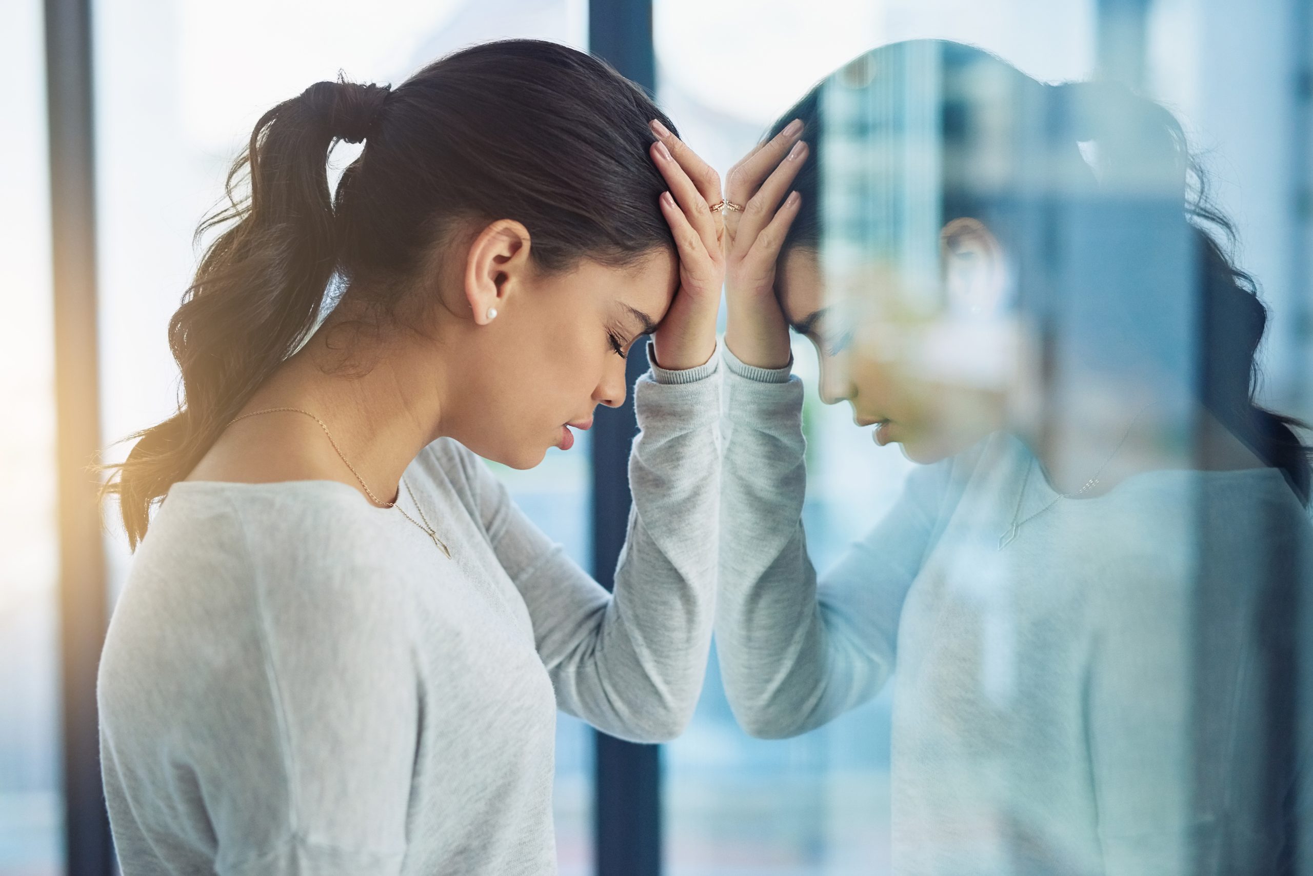 Shot of a young businesswoman looking stressed out in an office. ADHD Therapy - Edina MN - Minneapolis MN - Black woman with ADHD speaking with her therapist