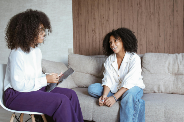 ADHD Therapy In Edina MN - Minneapolis MN - Black woman with ADHD speaking to her therapist ADHD Therapy - Edina MN - Minneapolis MN - Black woman with ADHD speaking with her therapist