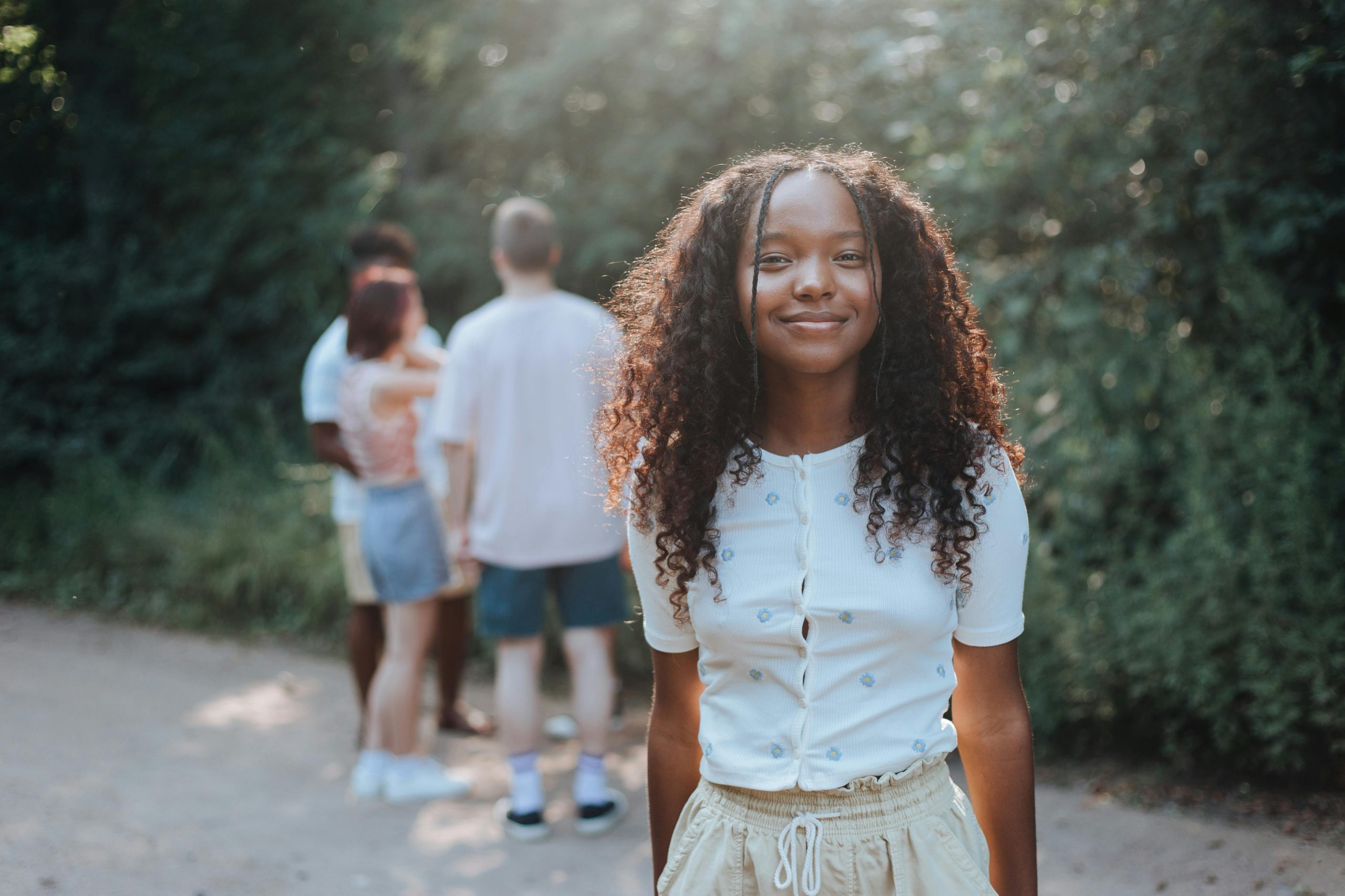 pexels-ron-lach-10484680 Happy teenager smiling with her friends in Edina, MN, teen therapy