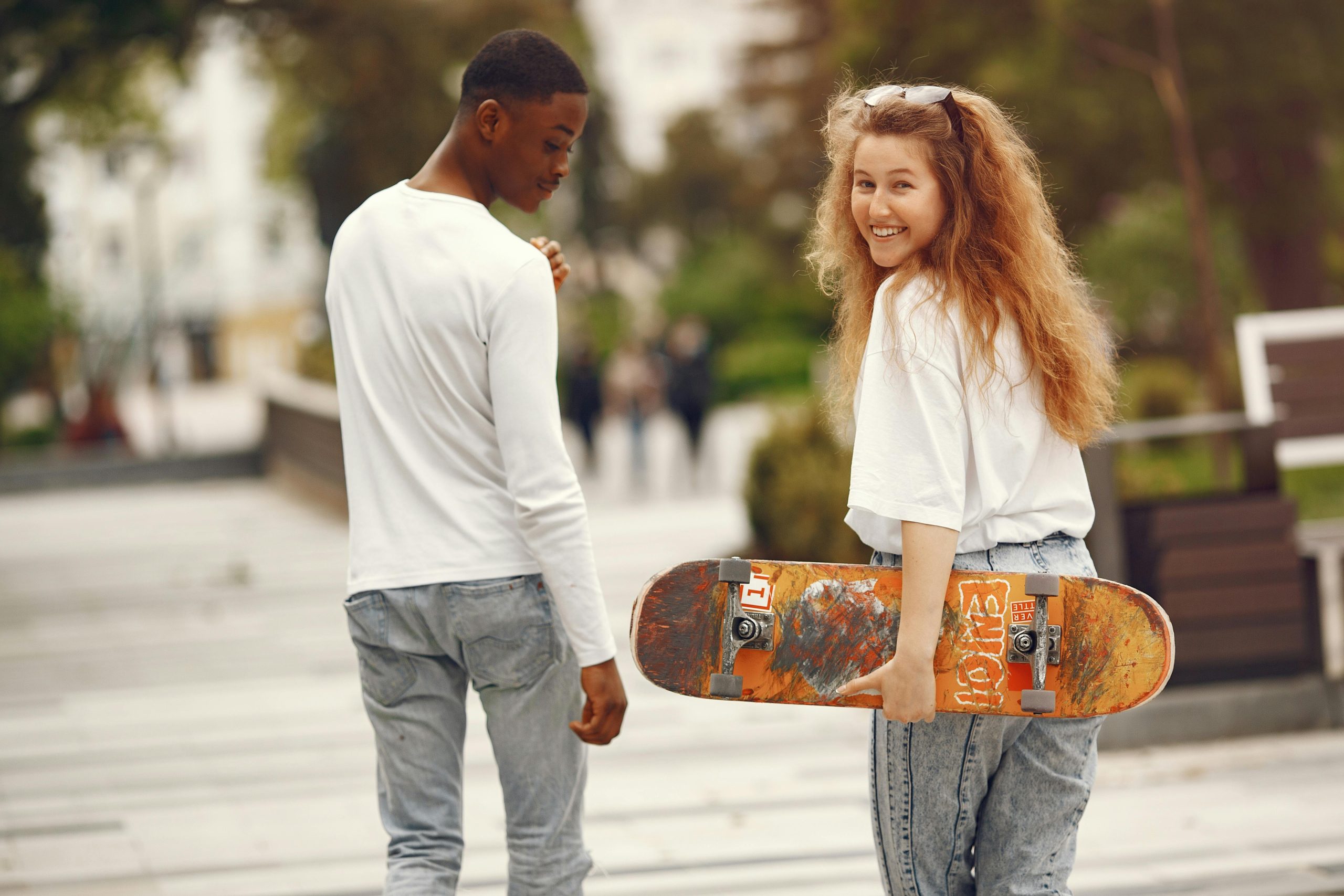 Happy teenagers in Minneapolis skateboarding outside
