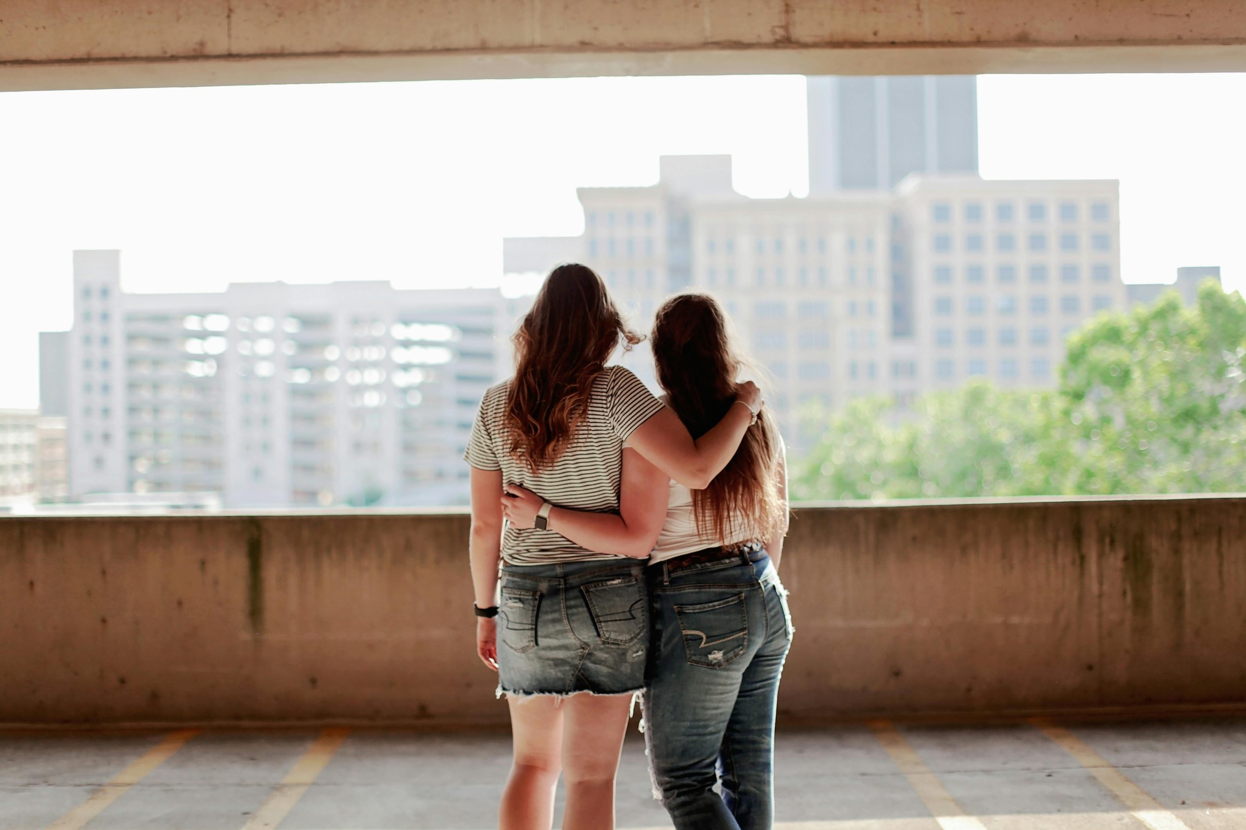 Two teenagers hugging while hanging out in Minneapolis, teen and adolescent therapy in Edina, MN